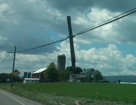 Broken pole hanging from wires