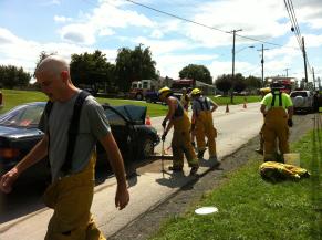 Firemen sweeping roadway