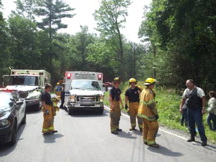 Firemen get information at the crash site